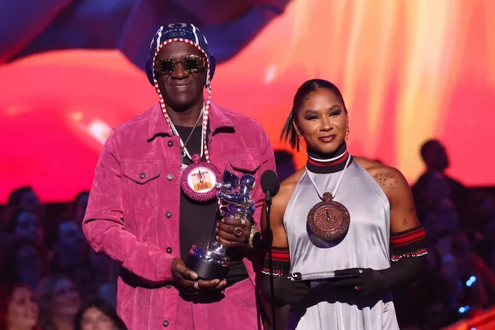 Flavor Flav in 2024 wearing his signature clock necklace, highlighting his music legacy, net worth, and reality TV career.
