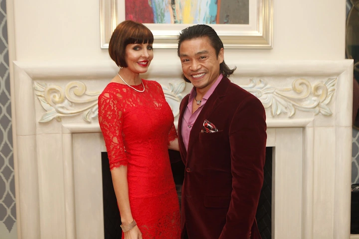 Dr Quang Henderson and his wife Linda Henderson smiling together, dressed elegantly at a formal event.