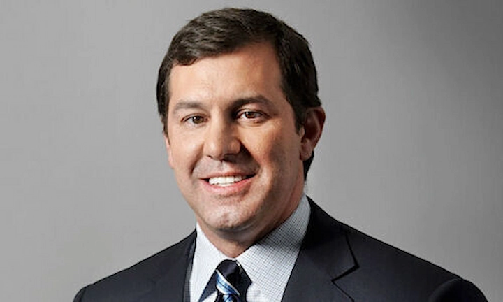 Eric Varvel in a suit, smiling, featured in an article about his net worth, career, and achievements