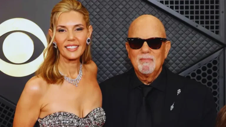 Billy Joel and wife Alexis Roderick posing together on the red carpet.