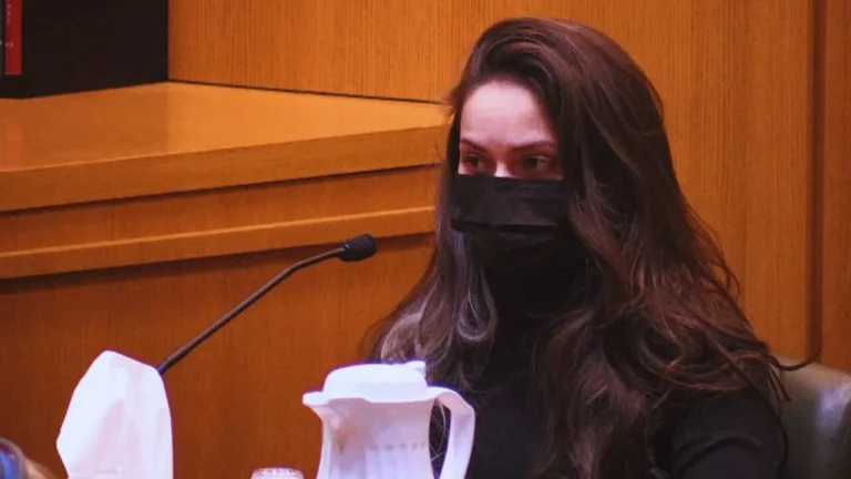 Cathryn Mellender testifies in court during Chandler Halderson’s murder trial, wearing a black mask.