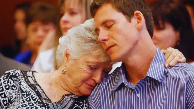 Grieving family members embrace in court during emotional murder trial testimony.