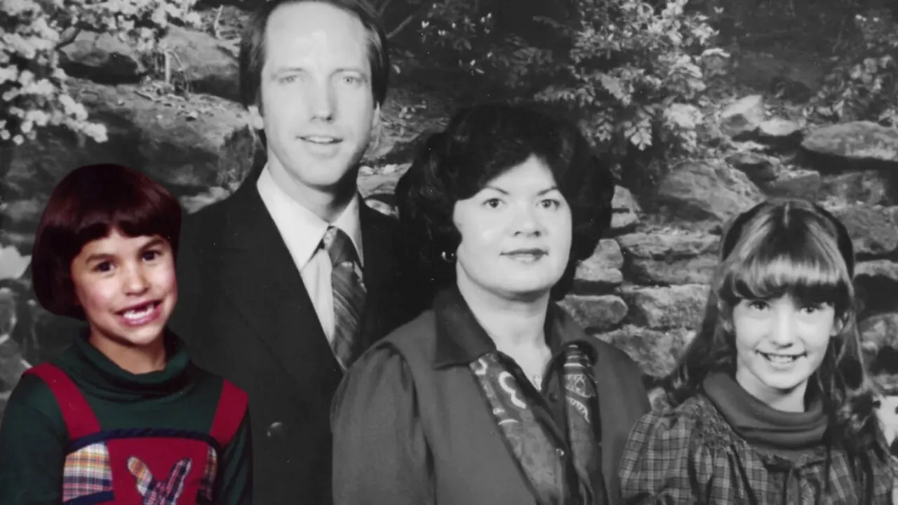 Black-and-white photo of Jonelle Matthews smiling with her adoptive family in the 1980s.