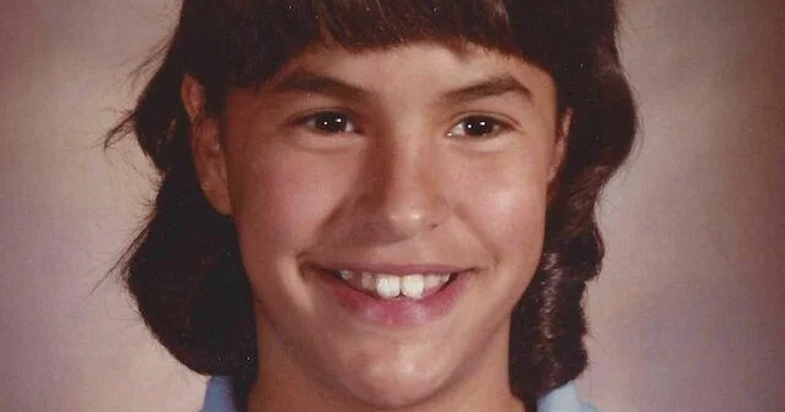 Smiling school photo of Jonelle Matthews with brown hair and a blue collared shirt.