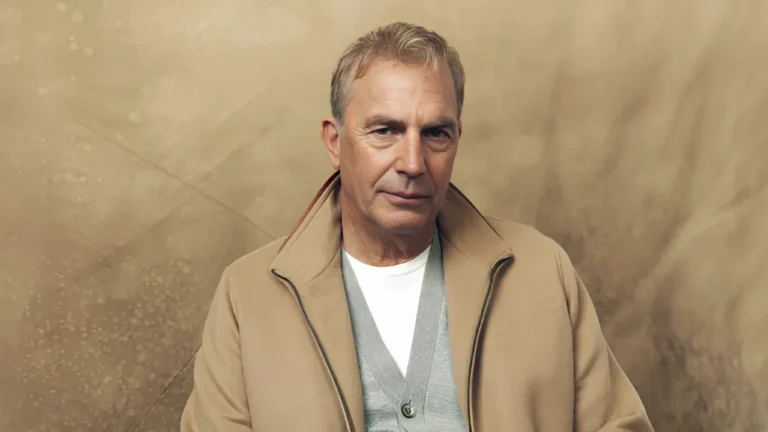 Kevin Costner poses in a beige coat with a neutral background amid Horizon 2 controversy.
