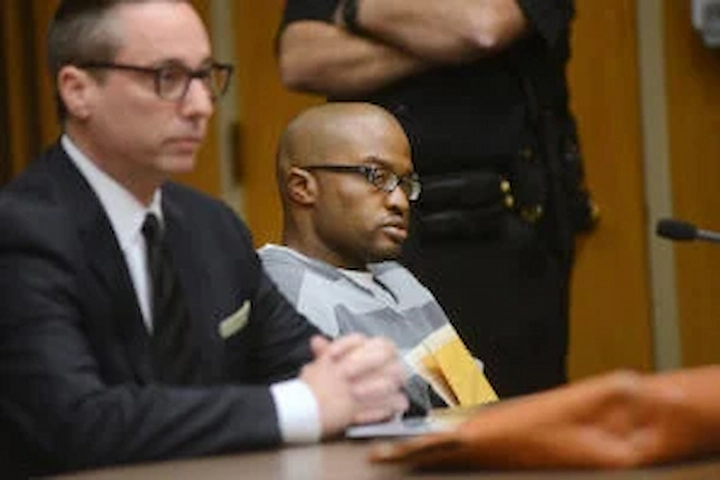 Gene Combs sitting beside his attorney in a courtroom during the Matt Garcia murder trial