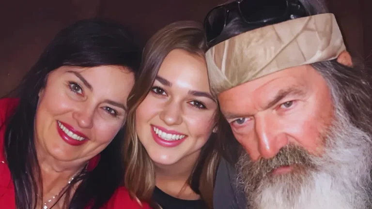 Sadie Robertson smiling with her grandfather Phil Robertson and a family member in a heartfelt moment.