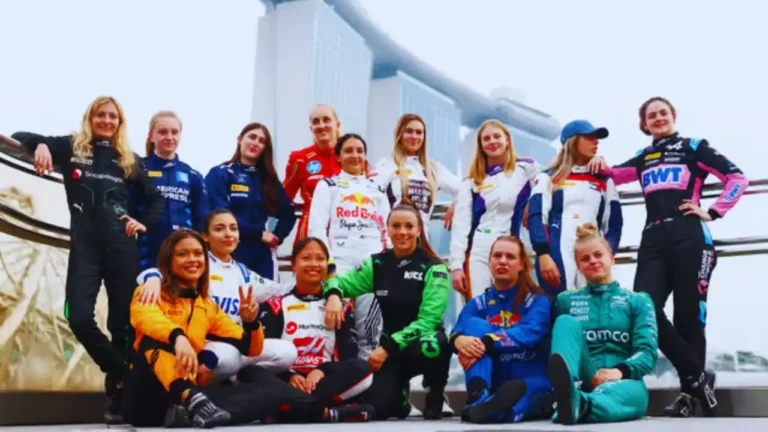 Female F1 Academy drivers pose together in racing suits in front of Marina Bay Sands.