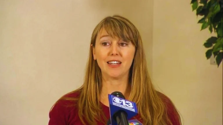 Sheila Koester speaking at a press conference with microphone.