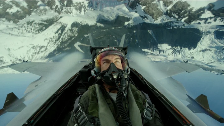 Tom Cruise as Maverick flying a fighter jet through snowy mountains in a Top Gun 3 action sequence.