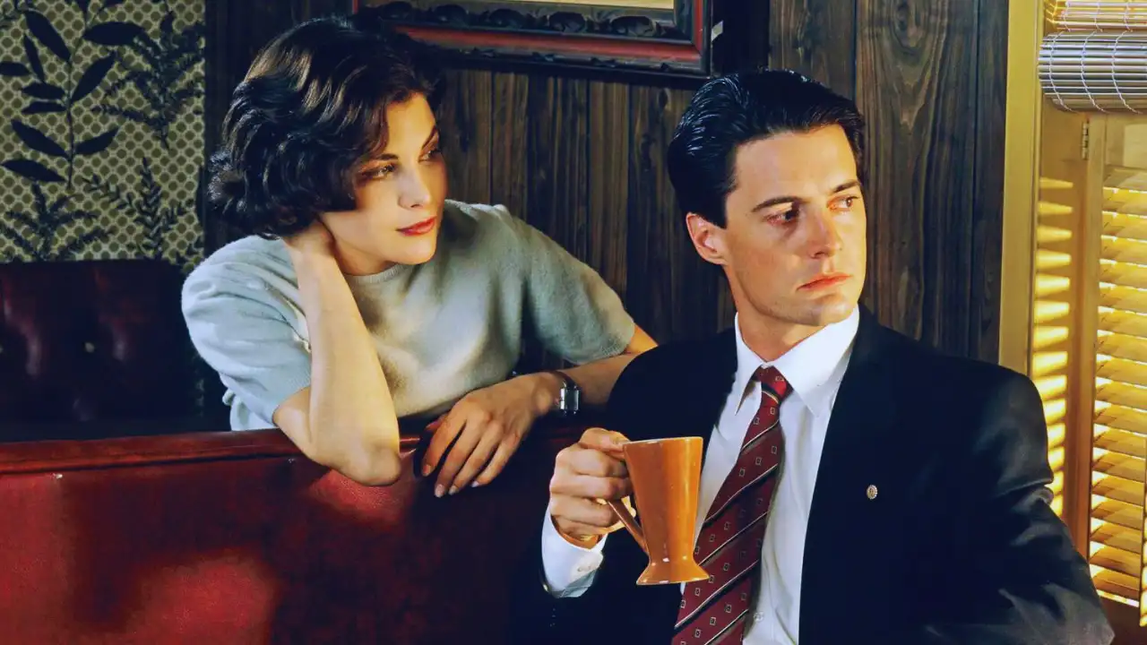 Audrey Horne gazes at Agent Dale Cooper inside the Twin Peaks diner.