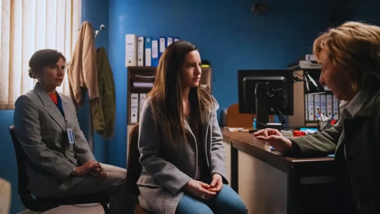 Interrogation scene from Netflix's A Widow’s Game, featuring key characters in police office.
