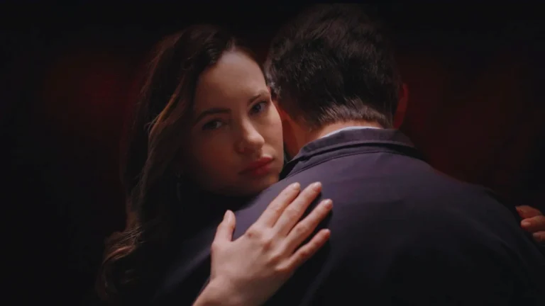 Maje embraces a man in Netflix’s A Widow’s Game, highlighting the film’s dark romance.