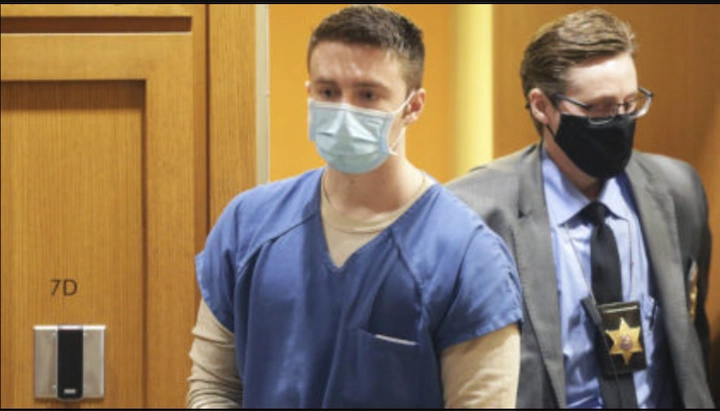 Chandler Halderson escorted in court wearing prison uniform and mask during his murder trial.