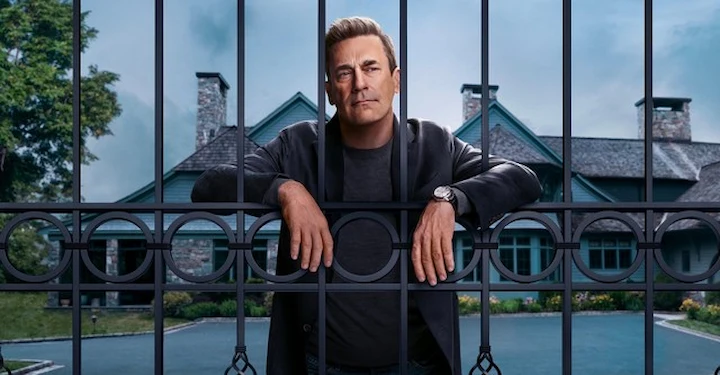 Jon Hamm as Coop behind black metal gate with mansion in background, Your Friends and Neighbors.