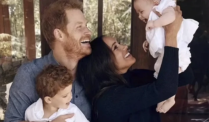 Prince Harry and Meghan Markle with Archie and baby Lilibet sharing joyful family moment.