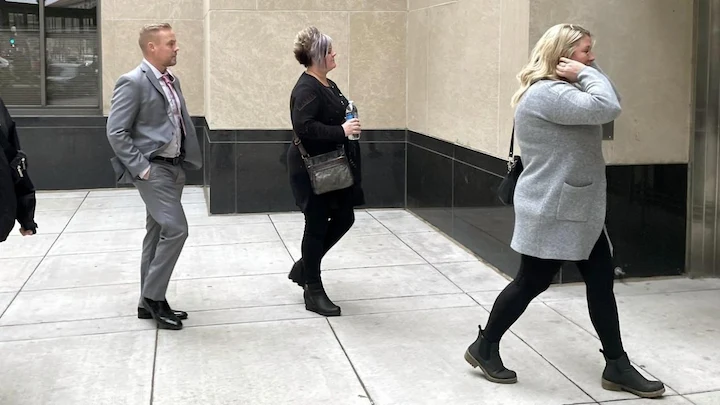 Family members and supporters walking into courthouse for trial hearing in Minnesota.