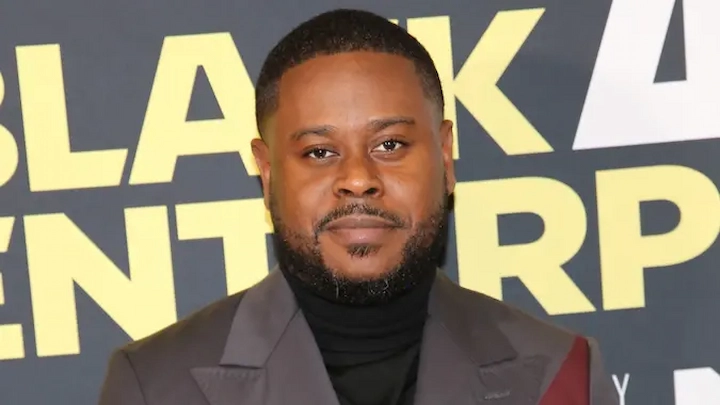 Anthony Oneal at a Black Enterprise event in a suit, standing in front of a branded backdrop.
