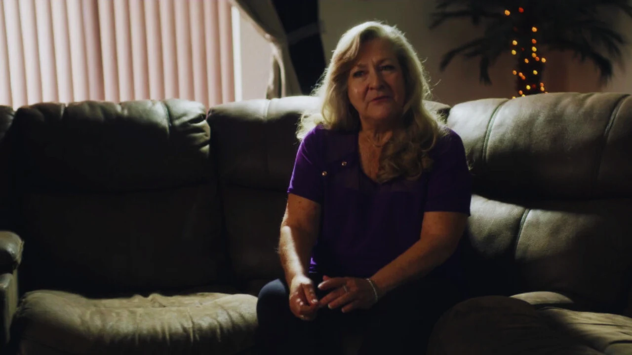 Barbara Hunt seated on couch, speaking about her life after ex-husband David Sconce’s crimes.