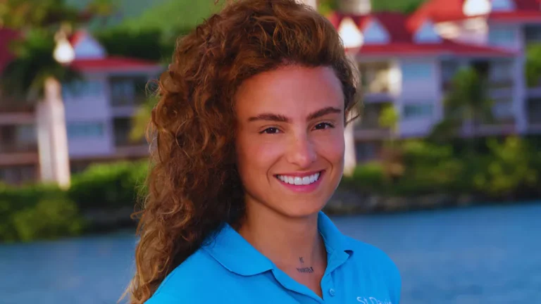 Barbara Kulaif smiling in a blue polo shirt with luxury yachts in the background.