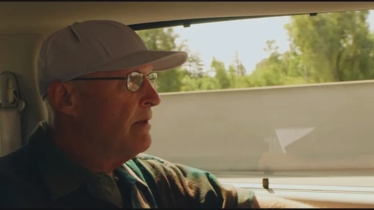 David Sconce driving in HBO’s The Mortician, former funeral director exposed for cremation crimes.