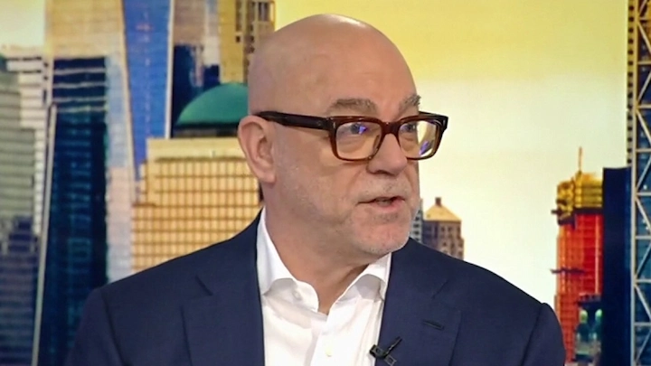 Donald Mullen in glasses and suit during a financial interview in New York