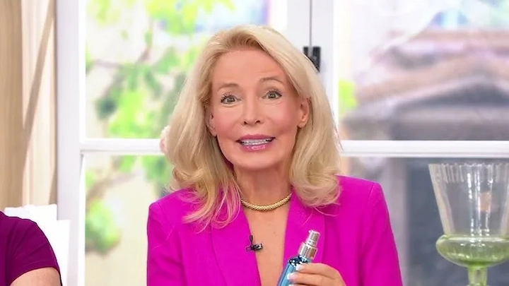 Dr Adrienne Denese presenting skincare product in pink blazer for Dr Adrienne Denese’s Net Worth 2025
