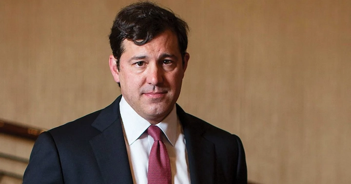 Eric Varvel in a suit, smiling, featured in an article about his net worth, career, and achievements