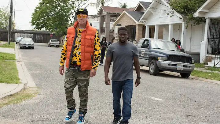 Will Ferrell and Kevin Hart walk through Darnell’s neighborhood in Get Hard movie scene.