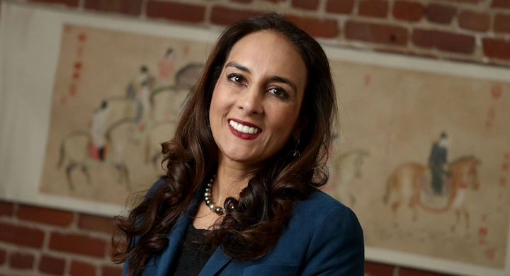 Harmeet Dhillon smiling in blue blazer, professional portrait related to Harmeet Dhillon’s Net Worth