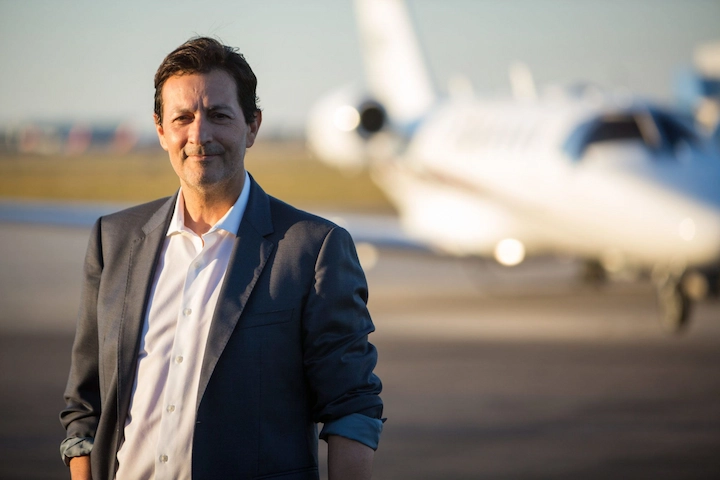 Harry Hedaya smiling near a private jet, symbolizing business success in 2025