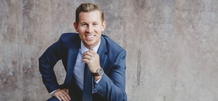 Jeremy Miner smiling in a blue suit, posing confidently for his 2025 net worth and success story article.