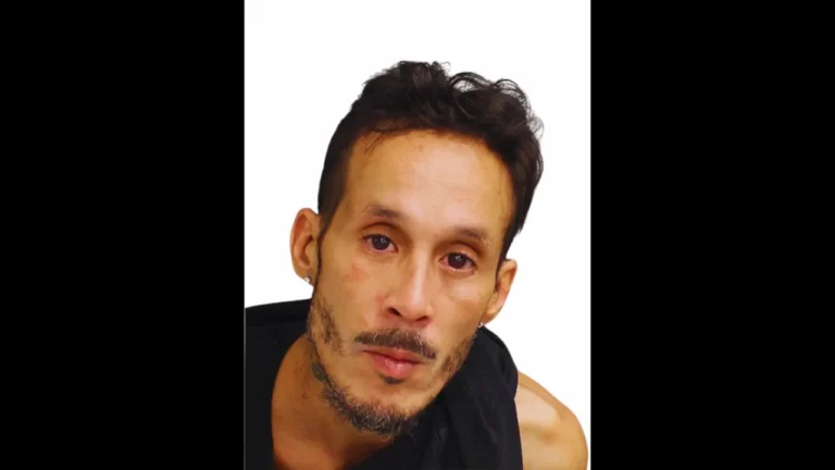 Portrait of Jorge Torres Jr. looking solemnly at camera, white background, visible facial features.