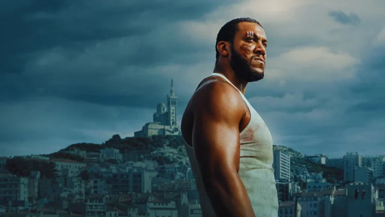 Bastien, bruised and contemplative, gazes over Marseille’s cityscape, embodying guilt and resolve.