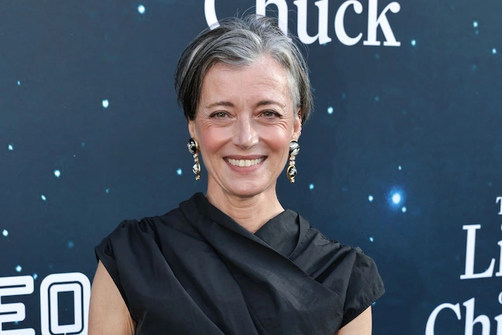 Mia Sara on the red carpet for The Life of Chuck premiere, smiling in an elegant black dress.