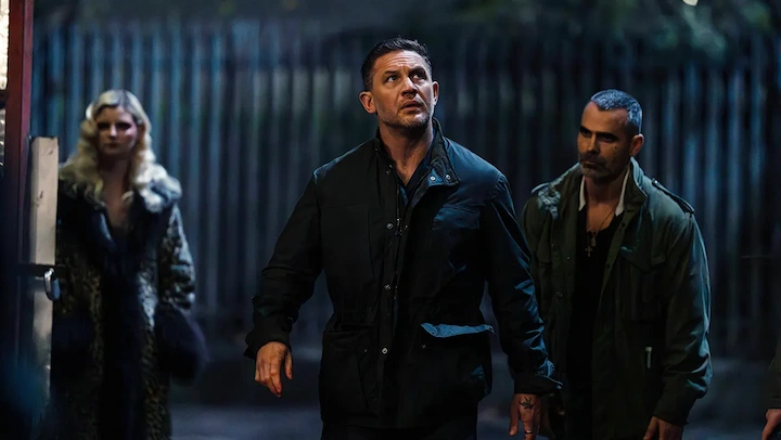 Tom Hardy as Harry Da Souza faces new threats in dark alley scene from MobLand crime drama.