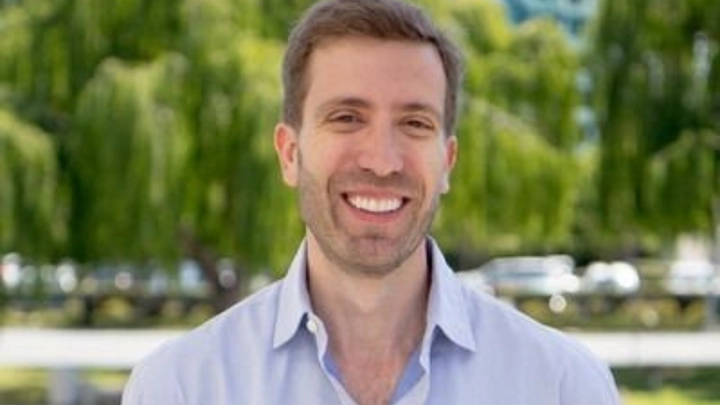 Paul Mishkin outdoors in a light blue shirt, representing IXL Learning and educational innovation
