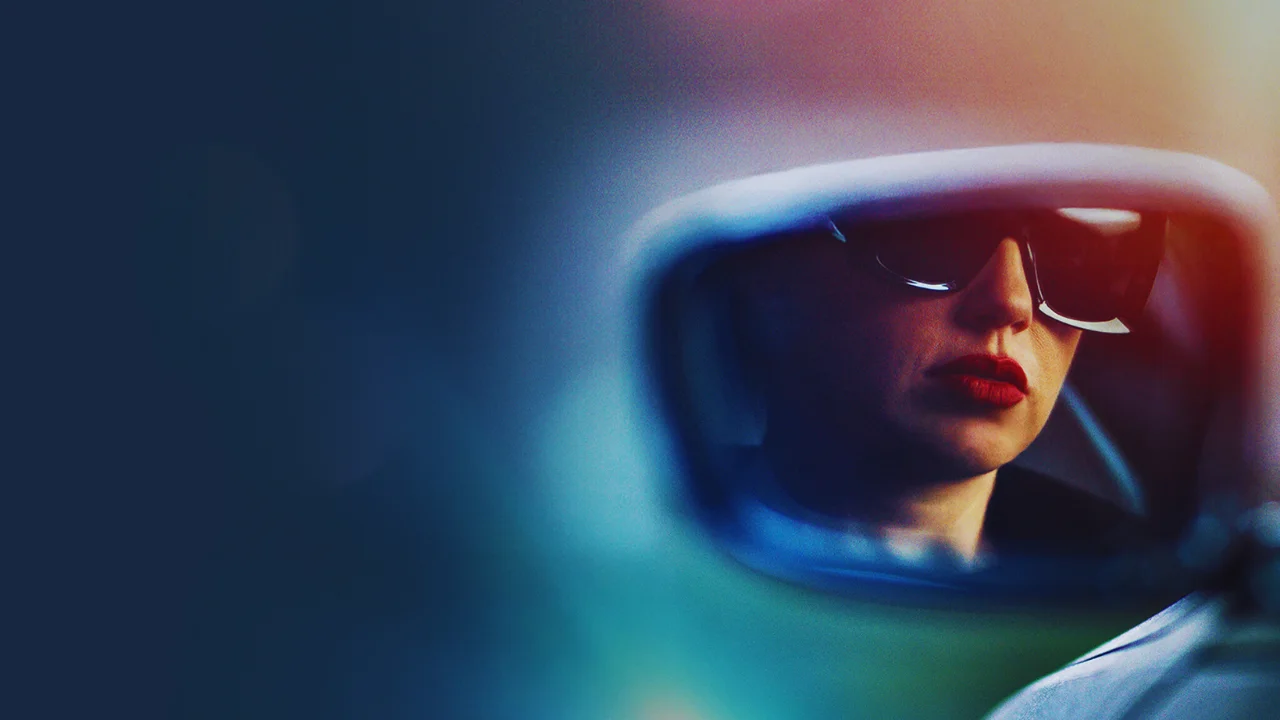 Woman reflected in car side mirror wearing sunglasses and red lipstick, evoking mystery and suspense.