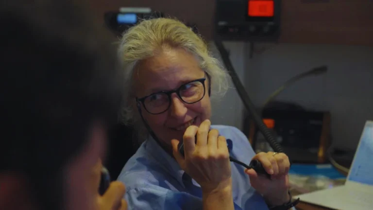 Wendy Rush communicating via radio aboard the Titan support vessel.
