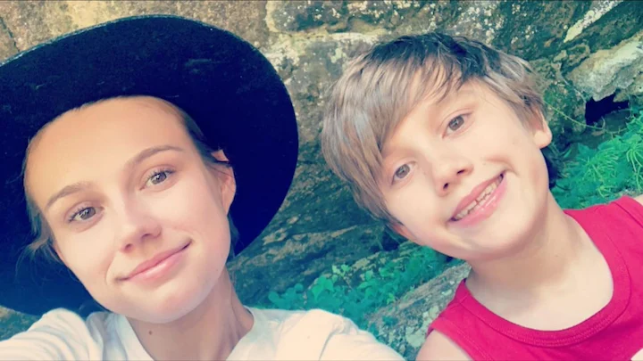 Weston Gosa Jr. smiling outdoors with a young woman in a nature setting.