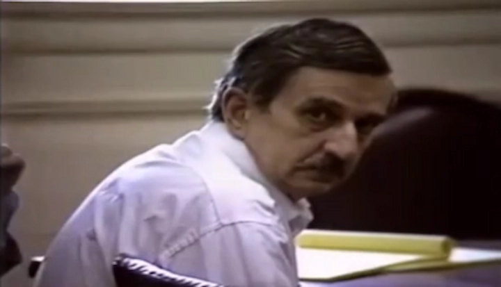 Donald Bent seated in court during his 1988 trial, glancing over his shoulder at proceedings.