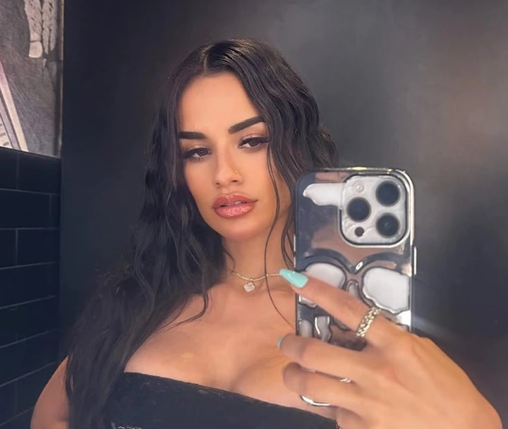 Yulissa Escobar takes a mirror selfie indoors wearing a black top, looking reflective after her public apology.